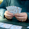 Woman playing cards with the Cape Cod map deck.