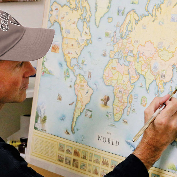 Co-Owner of Xplorer Maps, Chris Robitaille, painting the world map.