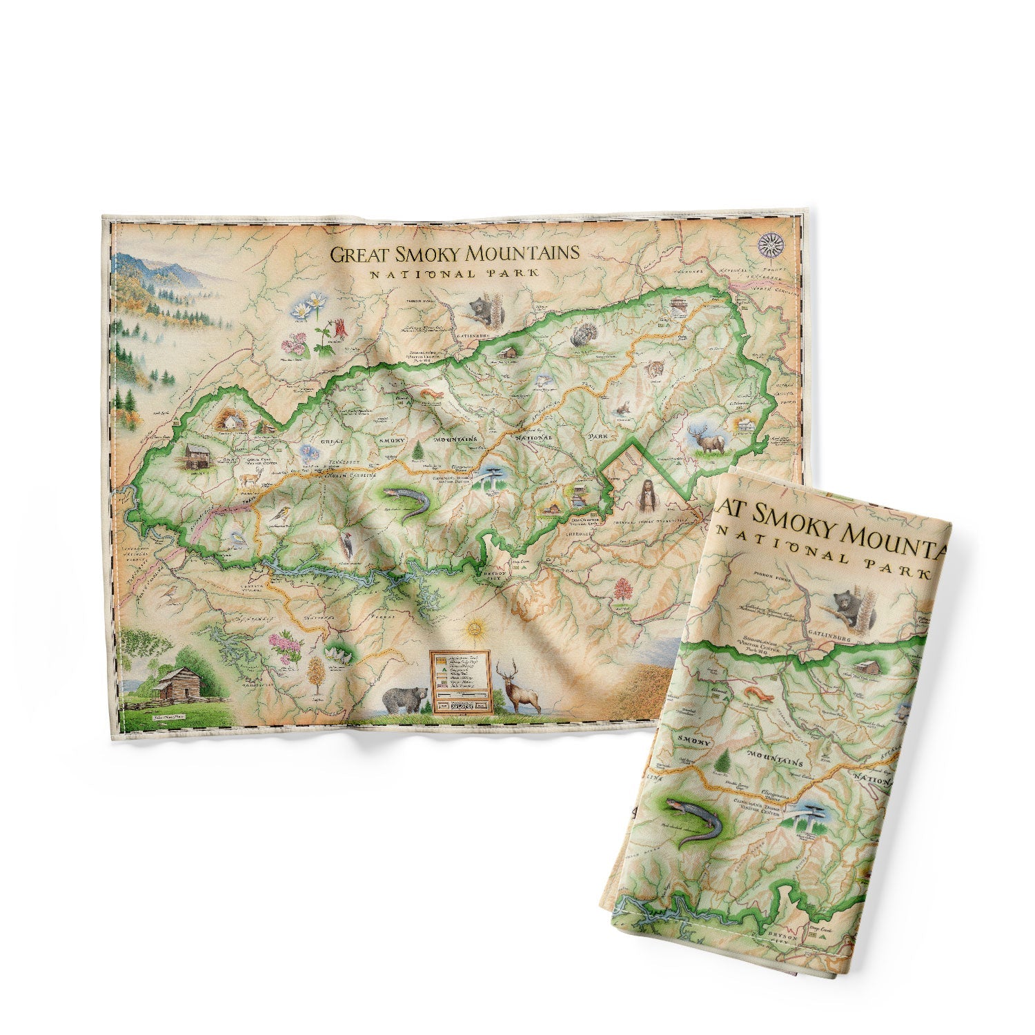 The Great Smoky Mountains National Park Map Kitchen Dishwashing Towel in earth tones colors of blue, beige, and green. The map depicts the entire National Park on the border of North Carolina and Tennessee. It features illustrations of a salamander, woodpecker, Clingman's Dome, Sugarland's Visitor Center, and Oconoluftee Visitor Center.