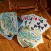 Playing cards with '1000 Islands' design on a wooden surface
