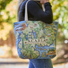 Tote bag with Acadia National Park map design held by a person outdoors.