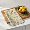 Wooden cutting board with Banff National Park map design on a kitchen counter.