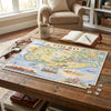 A completed vintage-style map jigsaw puzzle reading "CAPE MAY" is displayed on a rustic wooden table in a cozy living room setting, surrounded by a mug, open book, glasses, and loose puzzle pieces.
