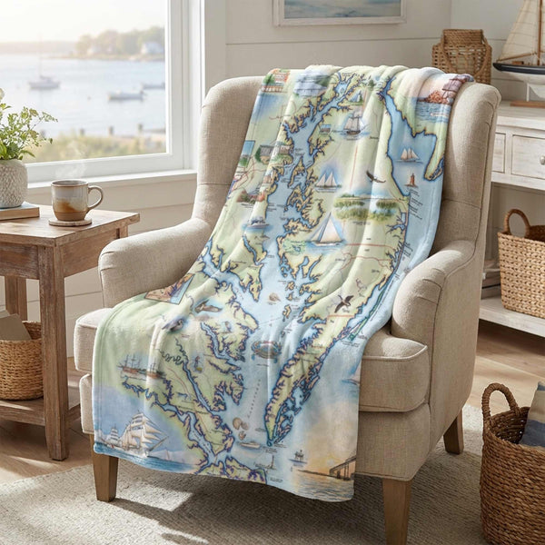 Map-themed blanket draped over a chair in a cozy living room.