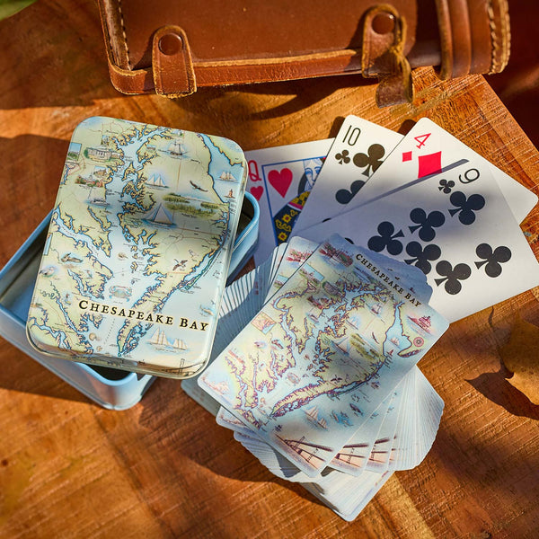 Playing cards with Chesapeake Bay map design on a wooden surface