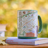 Mug with Great Smoky Mountains National Park map design on a book outdoors