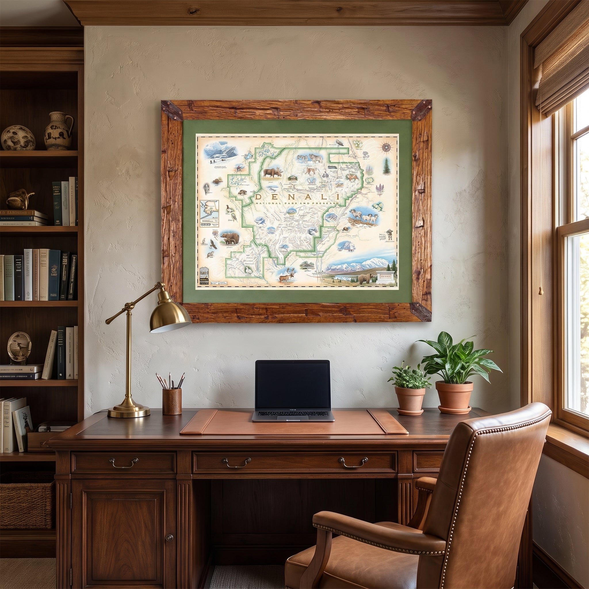 Denali map framed in pine wood and green mat hanging over an office desk. 