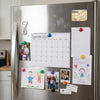 Stainless steel refrigerator with various magnets, photos, and notes attached
