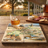 Glass of whiskey on a map of Kentucky with a charcuterie board in the background.