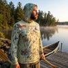 Man wearing a hoodie with Minnesota-themed design by a lake