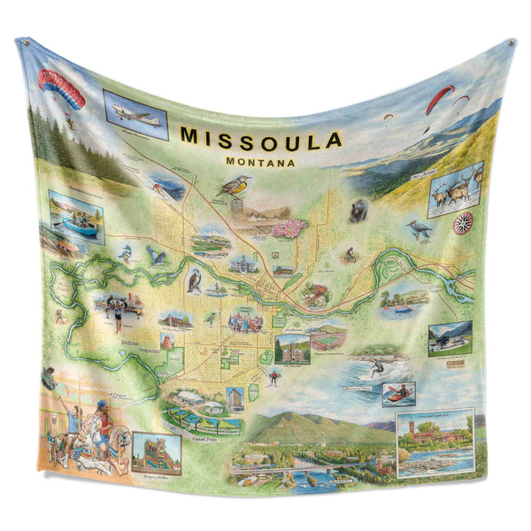 Hanging Missoula Map Fleece Blanket displaying detailed hand-drawn illustrations of the city's landmarks, rivers, and natural beauty.