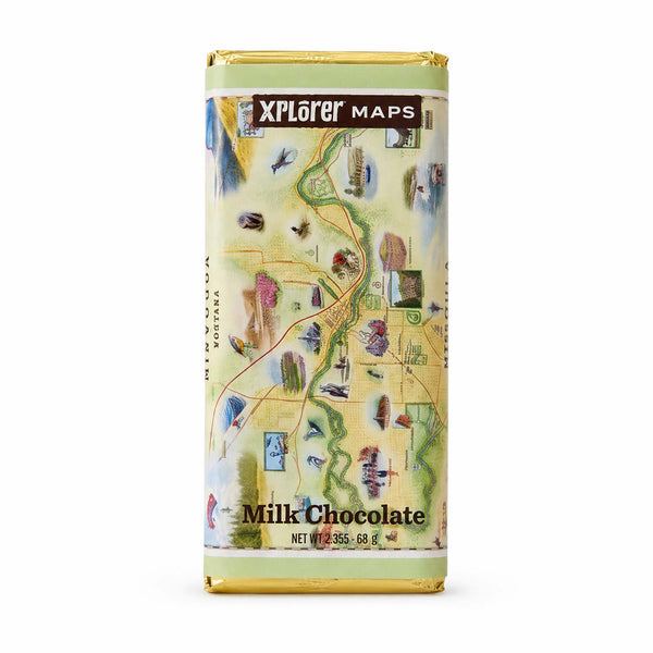 A milk chocolate bar wrapped in gold foil with a detailed illustrated map of Norway on the front, labeled 'Xplorer Maps' and 'Milk Chocolate'.