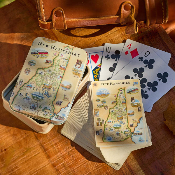 Playing cards with New Hampshire map design on a wooden surface
