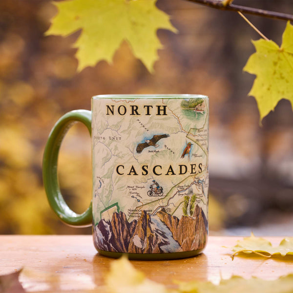 North Cascades National Park Map Ceramic Mug – 16 oz with fall leaves in background