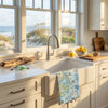 Kitchen with a sink and window view of beach scenery