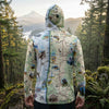 Person wearing a map-themed hoodie in a forest setting