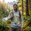 Man wearing a hoodie with 'Oregon' and map design in a forest setting