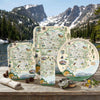 Set of serving trays with Rocky Mountain National Park design on a wooden surface with natural background