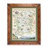 A framed vintage-style map of Rocky Mountain National Park, featuring a rustic brown wooden frame, olive green matting, and a detailed illustrated map with animals and landscape scenes.