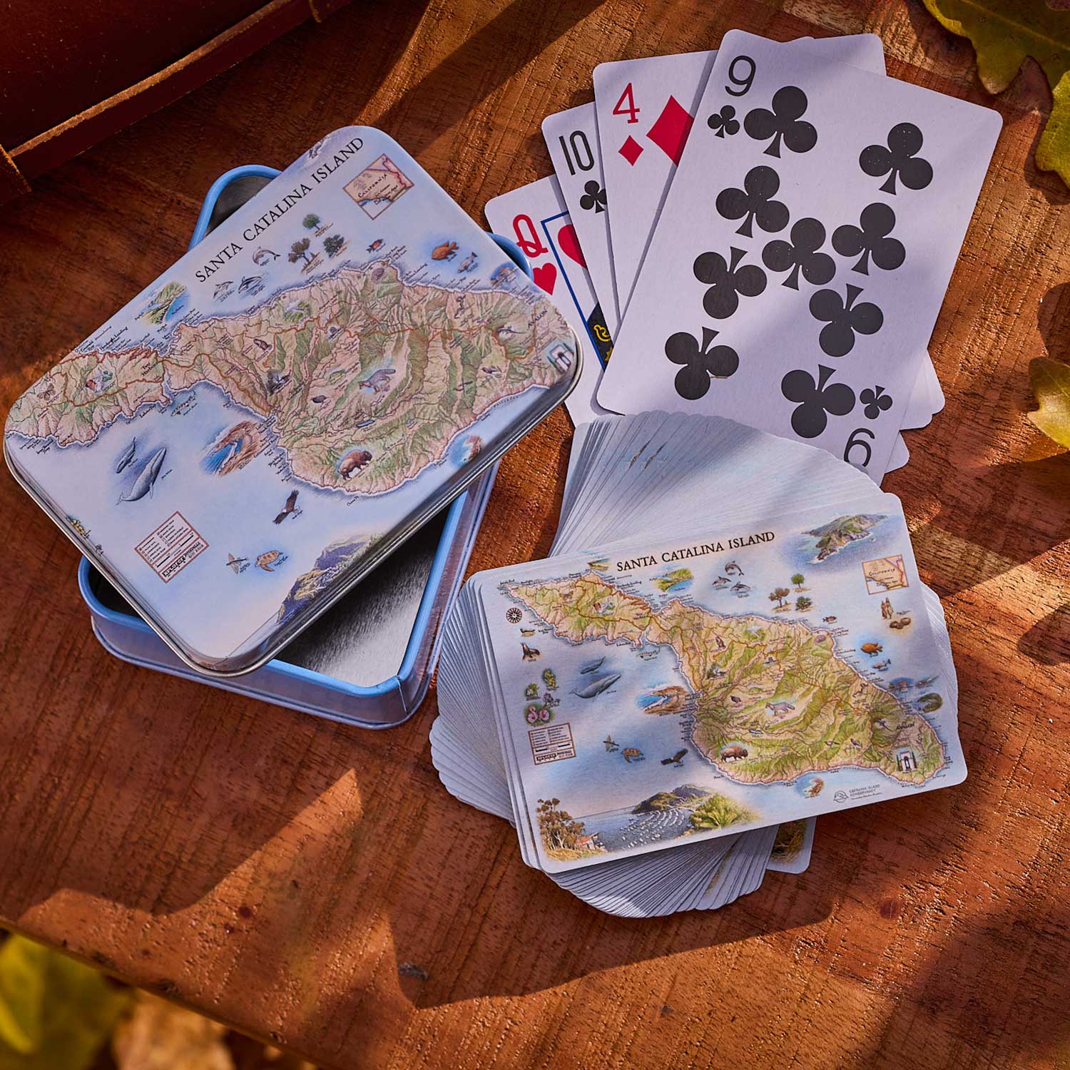 Playing cards with Santa Catalina Island map design on a wooden surface