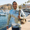 Man wearing a hoodie with Santa Catalina Island map design by a waterfront.