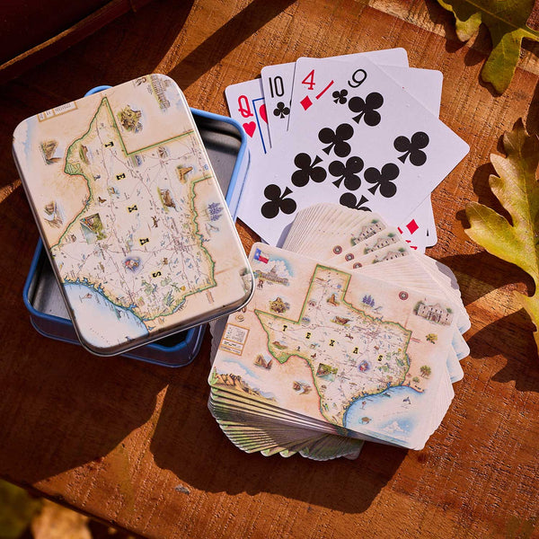 Playing cards with map design on a wooden surface