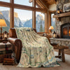 Cozy living room with a map-themed blanket draped over a chair, stone fireplace, and mountain view.
