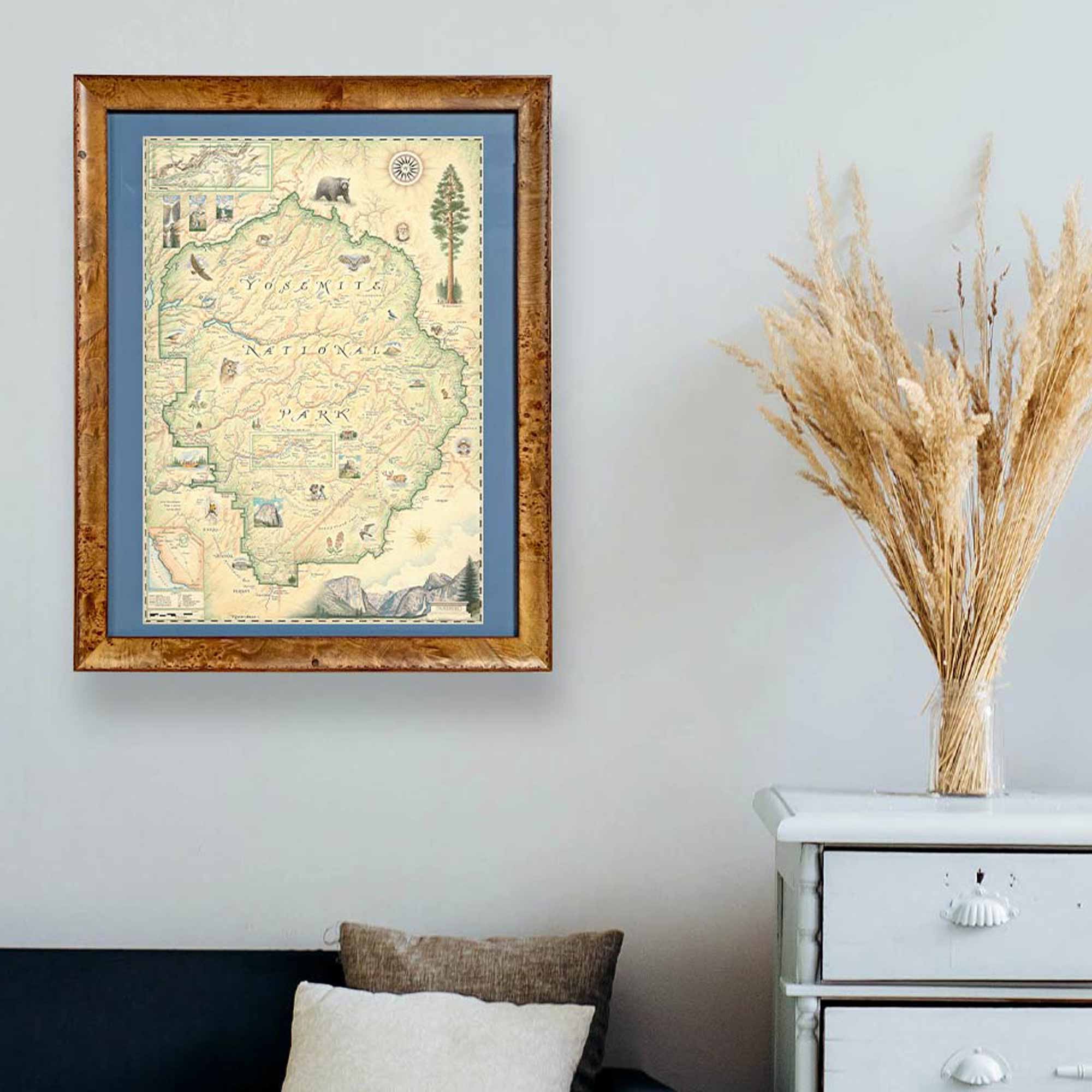 Xplorer Map of Yellowstone National Park hangs framed on a wall above a fireplace.
